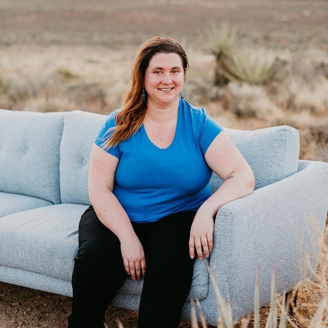 Heather Cirmo, therapist, sitting on couch