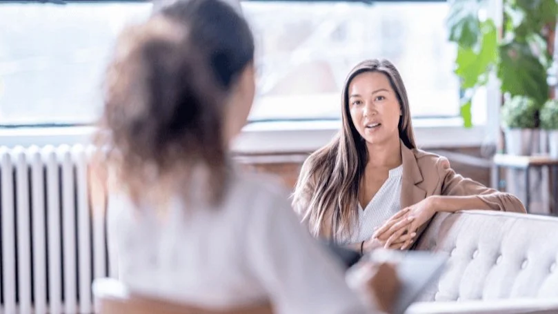 Two people in conversation during a therapy session