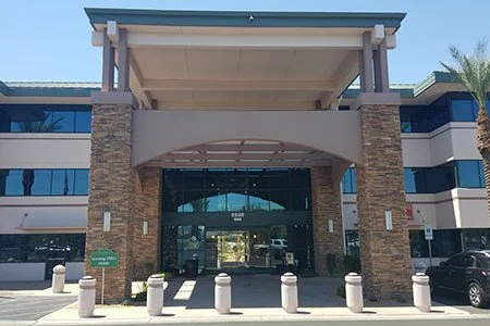 Modern office building entrance with stone and glass facade