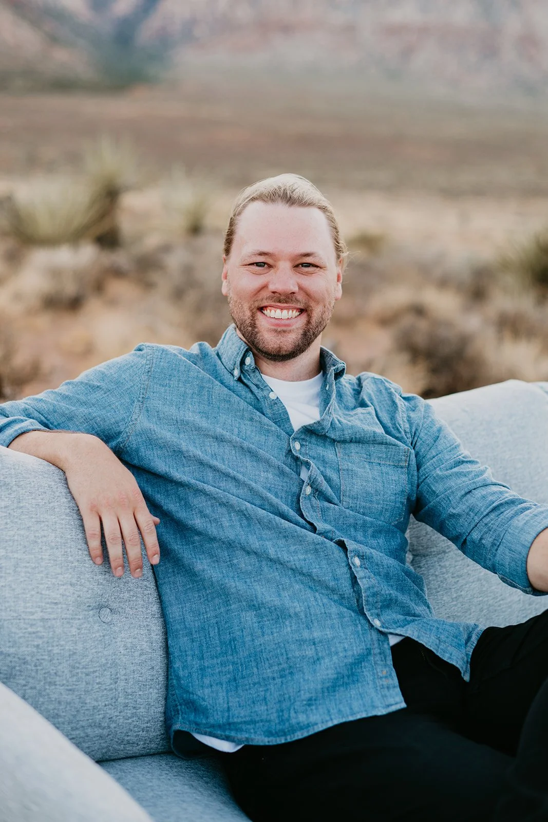 Ryan Greenwood, therapist at Hello Calm, sitting on couch